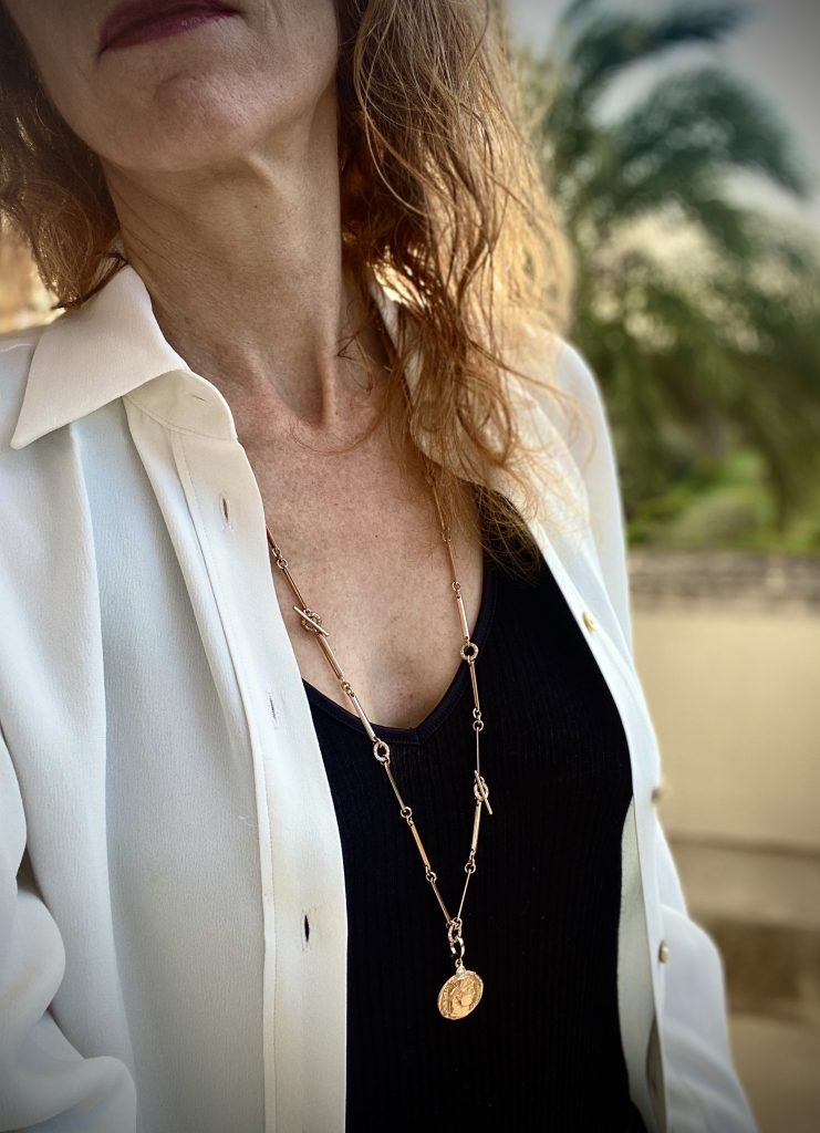 woman wears talisman chain